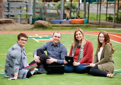 Group of teachers sitting outdoors