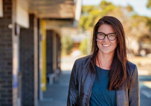 Female teacher outside school building