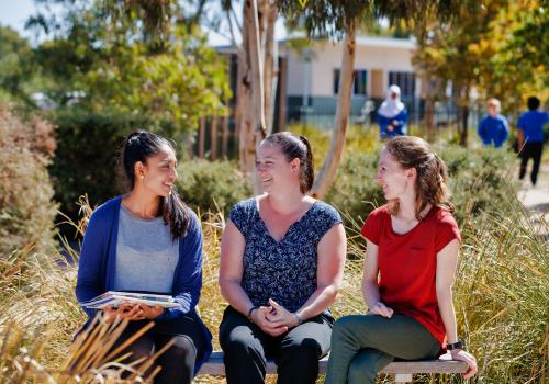 Women leaders in a school having a discussion outside