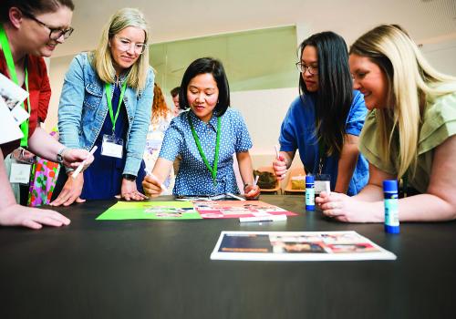 Image of people gathered in circle doing an activity. 