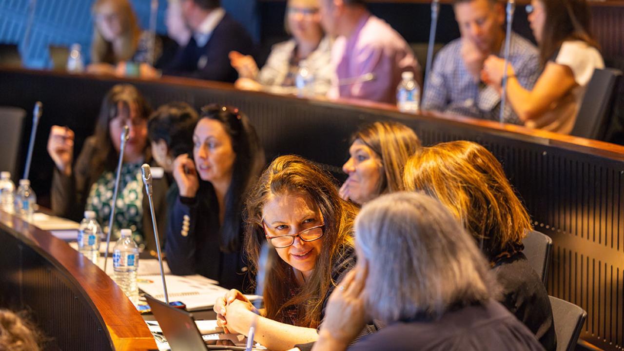 Participants seated in theatre audience in discussion 
