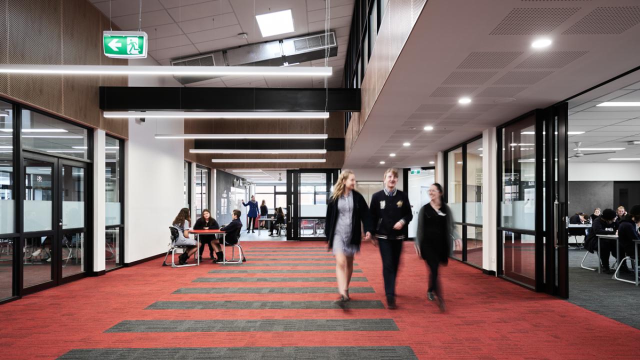 High school students walking through school corridor
