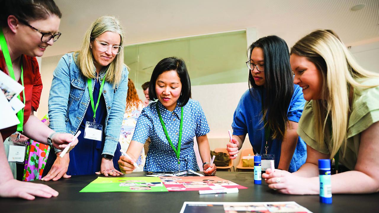 Image of people gathered in circle doing an activity. 