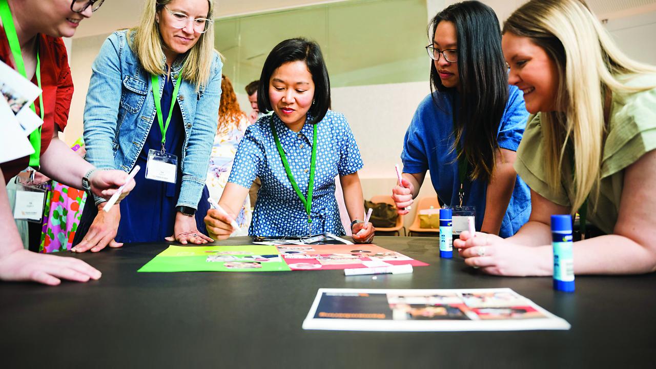 Image of people gathered in circle doing an activity. 