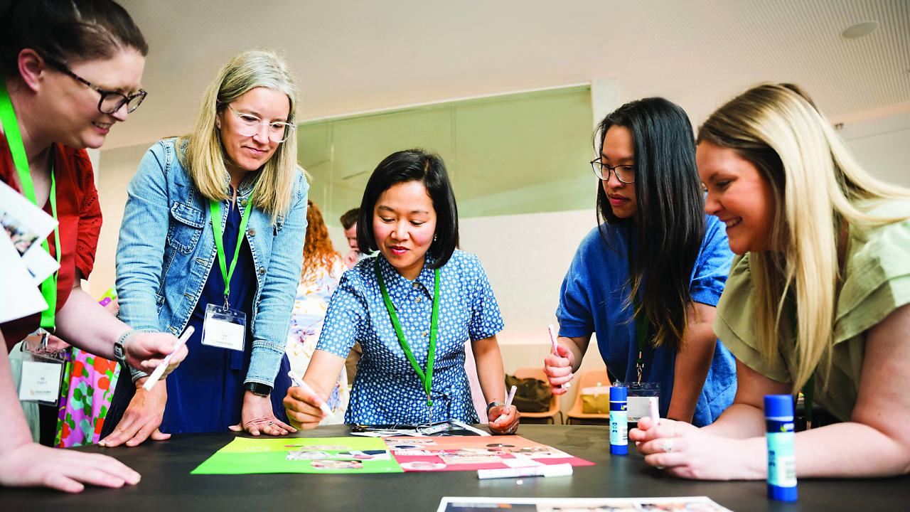 Image of people gathered in circle doing an activity. 