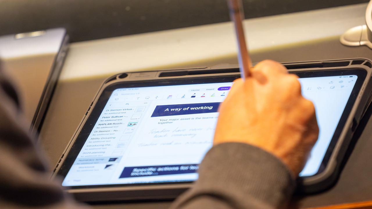 Close up of participant working on an ipad