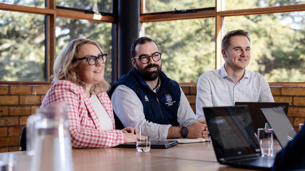 Image of female senior leader with two male colleagues, one colleague being a young teacher.