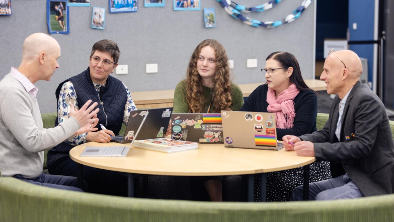 five educators around table discussion