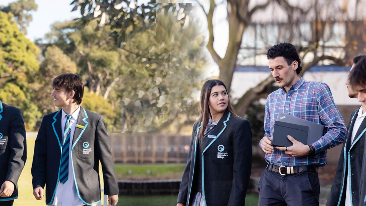Teacher with students in discussion outdoors. 