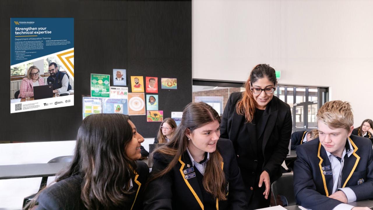 teacher in class leaning in to assist 3 students