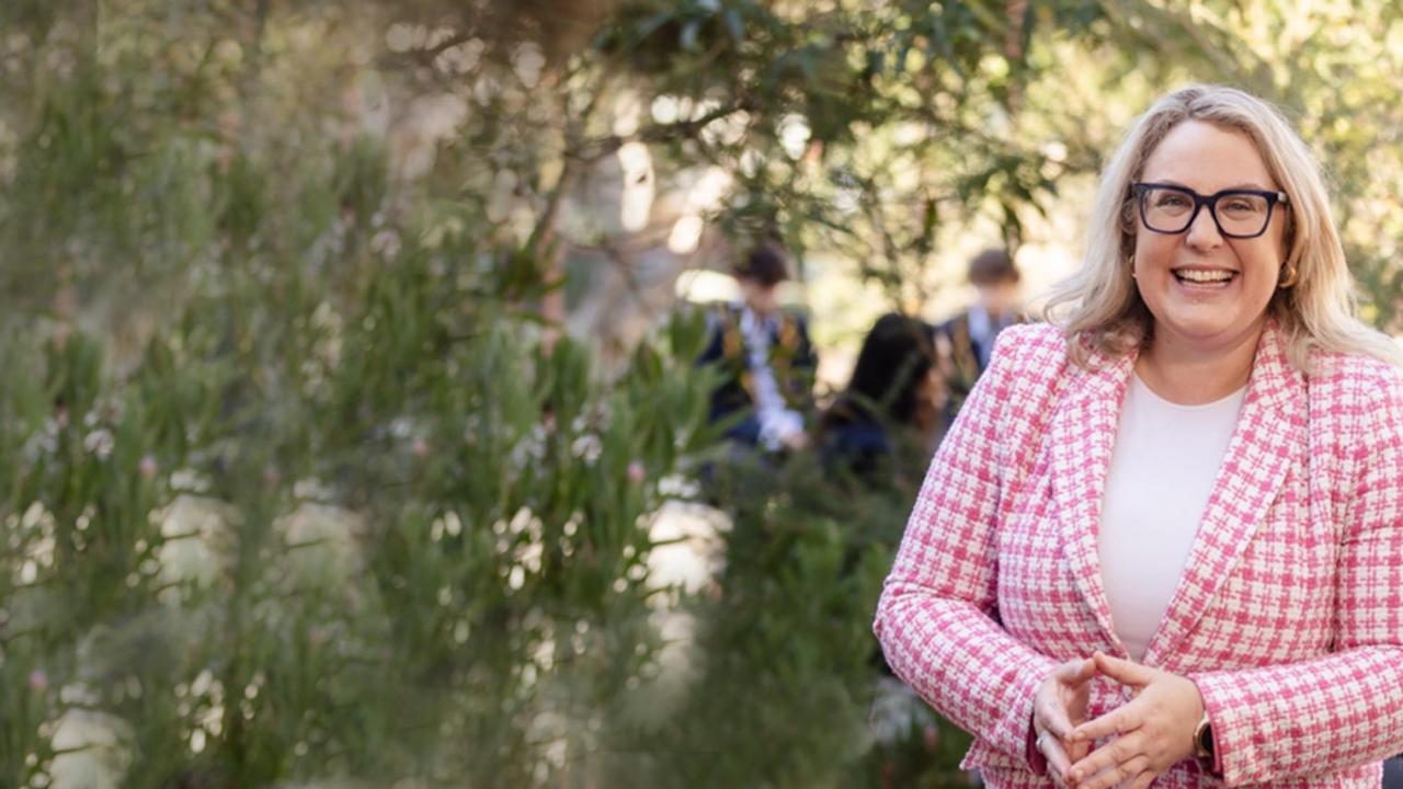 Sandringham Secondary college teacher. Pink jacket. Black Glasses, Big smile
