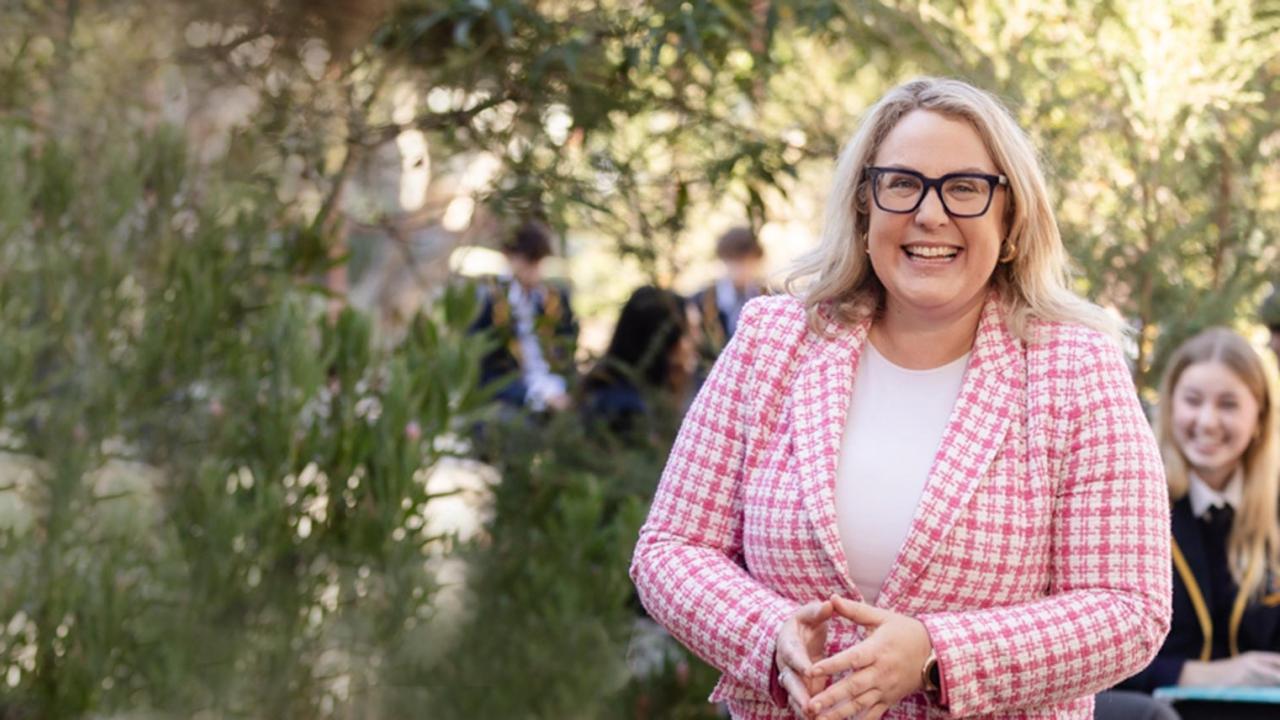 Sandringham Secondary college teacher. Pink jacket. Black Glasses, Big smile