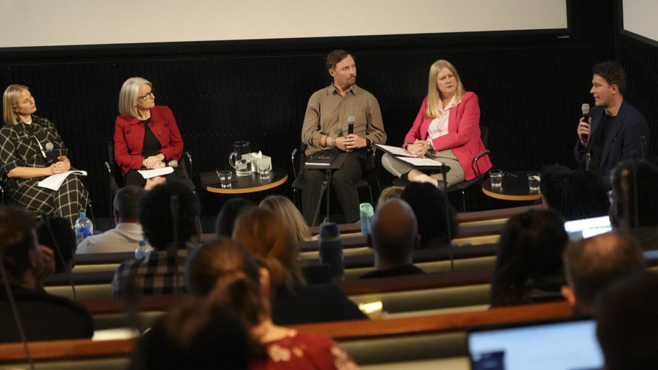 AI Symposium Panel Discussion in an auditorium