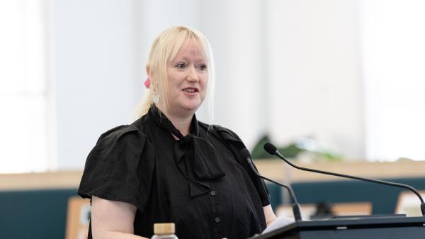 Christine Blake, Ambassador standing at podium
