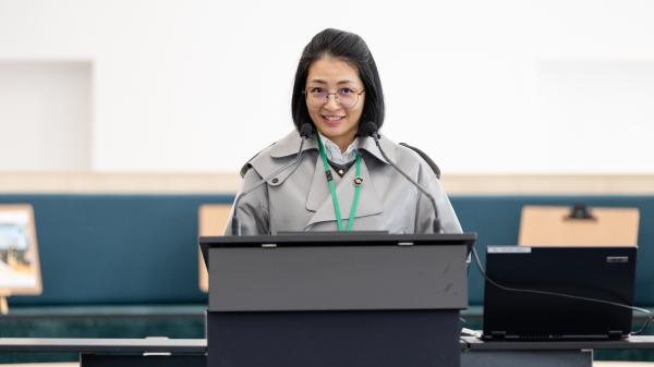 Rhoda Fu standing at podium