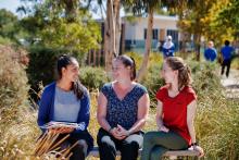 Women leaders in a school having a discussion outside