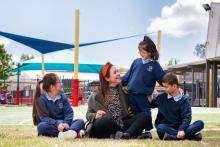 Teacher with young students outside