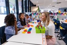 Teacher working on counting with primary school students at their desks