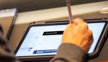 Person writing notes in a tablet