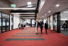 High school students walking through school corridor
