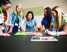 Image of people gathered in circle doing an activity. 