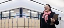 Leading teacher smiling proudly in school corridor