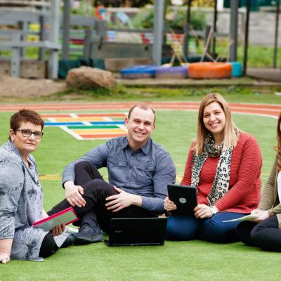 Group of teachers sitting outdoors