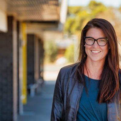 Female teacher outside school building