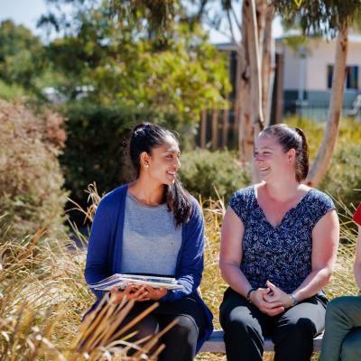 Women leaders in a school having a discussion outside