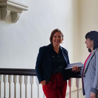 2 participants standing in front of staircase