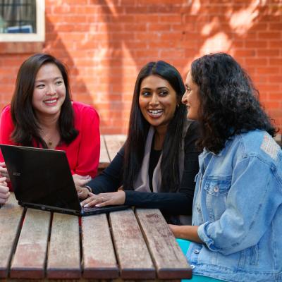 Teachers having discussion at a table outdoors