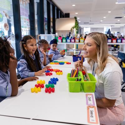Teacher working on counting with primary school students at their desks