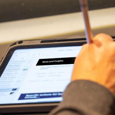 Person writing notes in a tablet