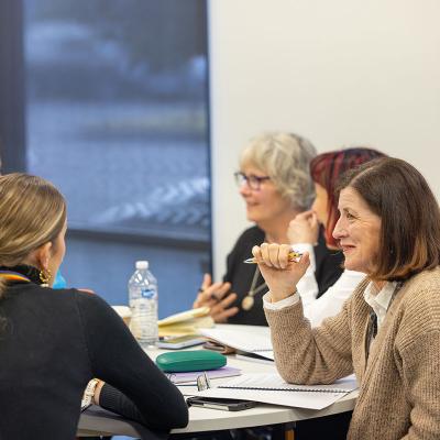 Participants seated around table in discussion during a workshop 