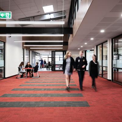 High school students walking through school corridor