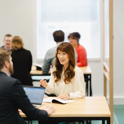Participants seated at table in discussion during a workshop