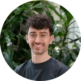 Profile picture of Aaron Silver standing near green shrubs