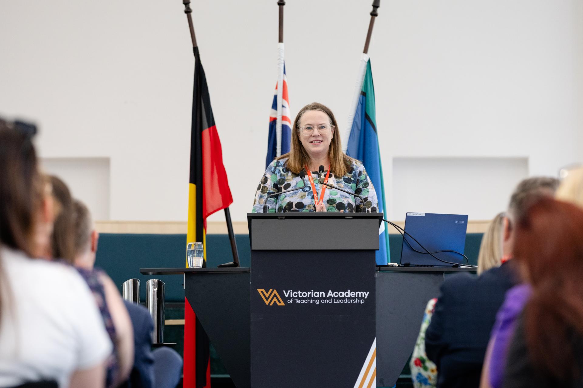 Dr Fiona Longmuir standing at podium 