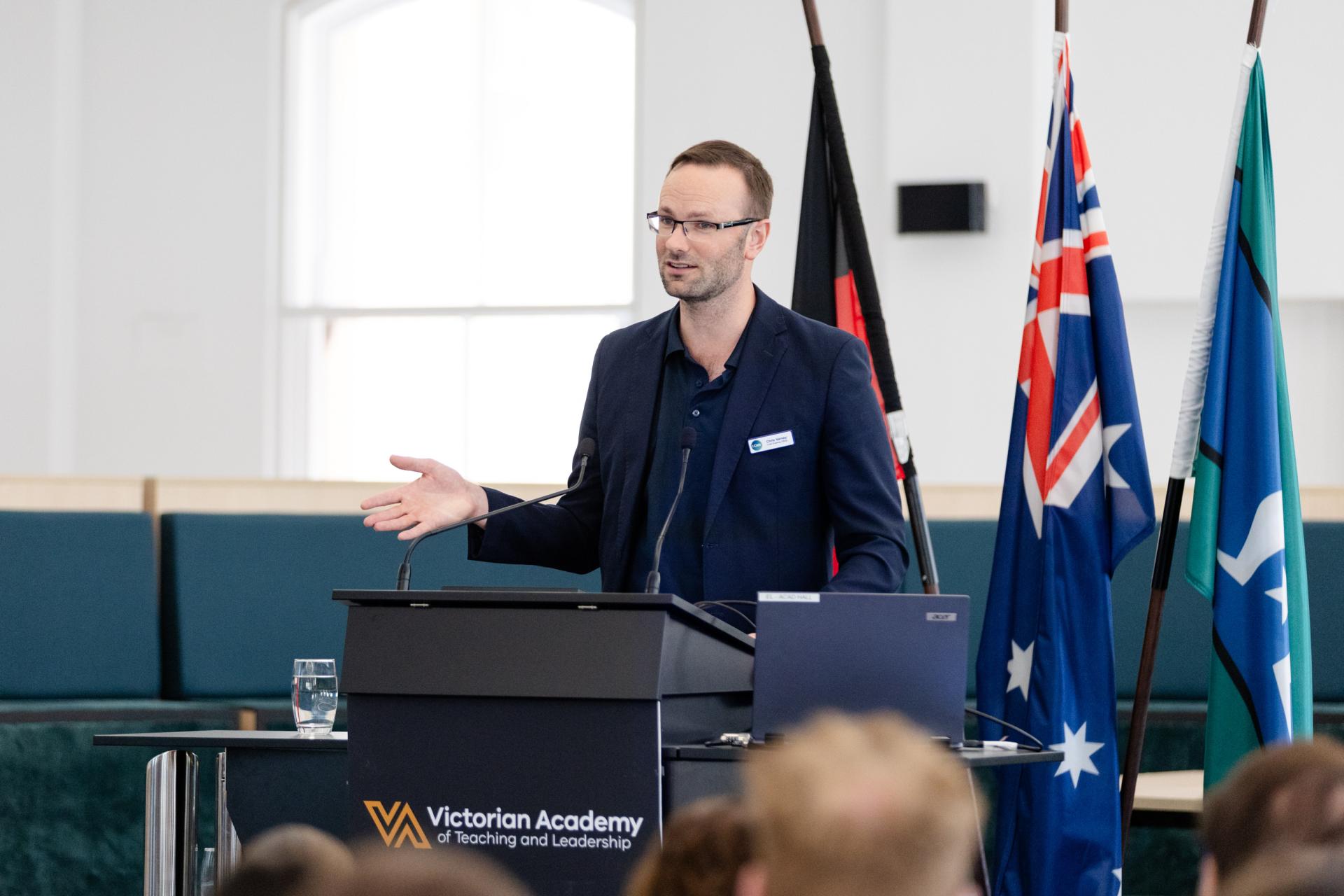Chris Varney presenting at lectern