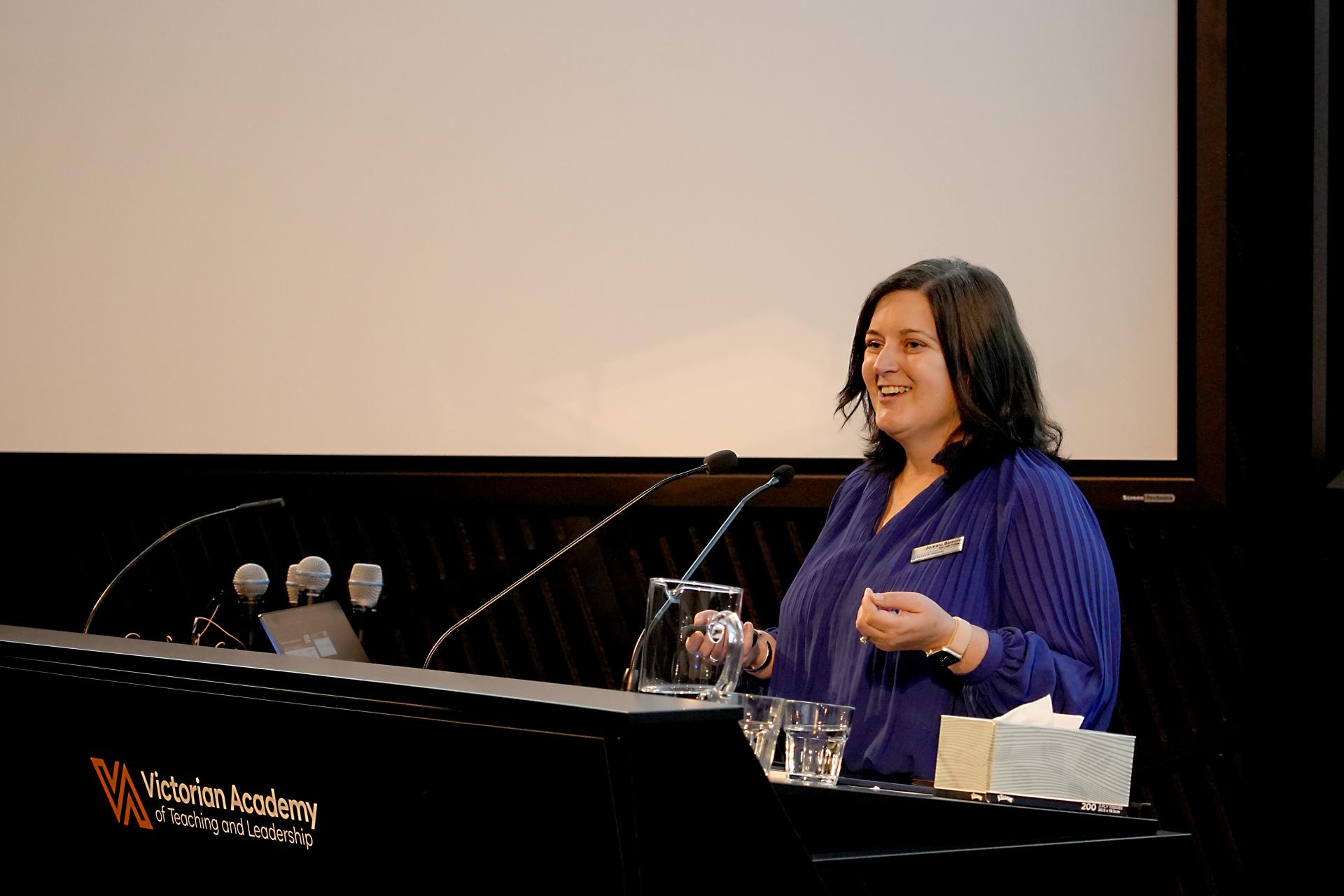 A/prof Jo Blannin speaking at a lectern 